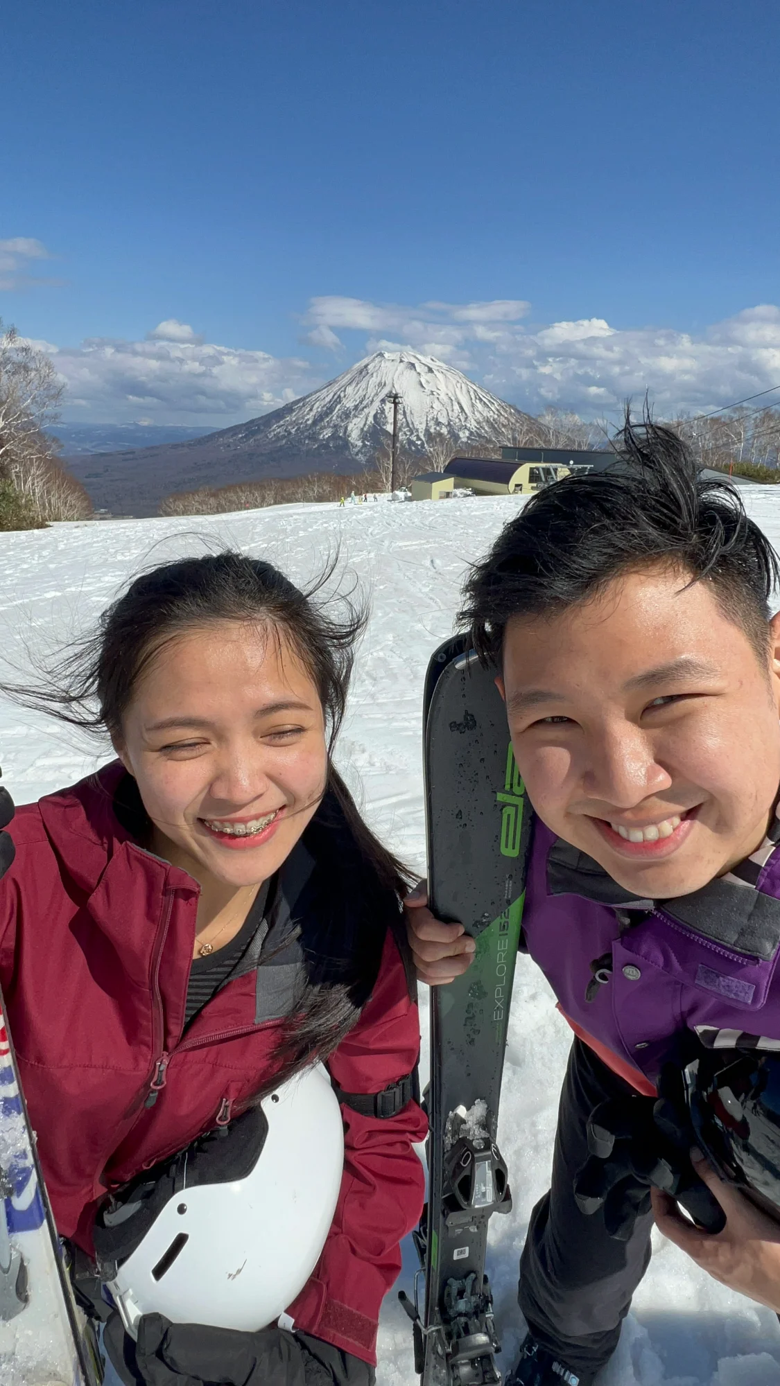 Skiing couple with Mt Yotei